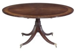 A mahogany circular topped table in Regency style, 20th century, the circular radiating top with