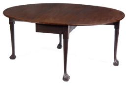 A George II mahogany oval drop leaf dining table, circa 1740, the top incorporating a pair of