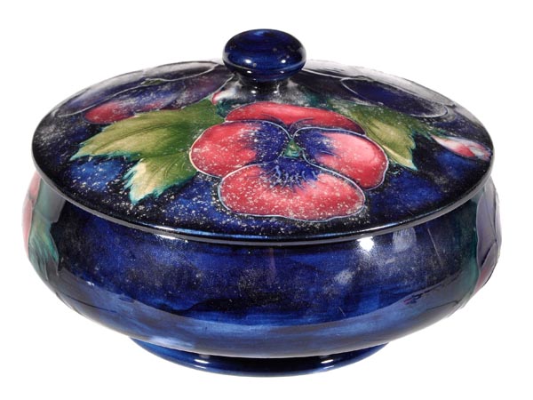 A William Moorcroft ‘Pansy’ powder bowl and cover, 14cm diameter, script and impressed marks, paper