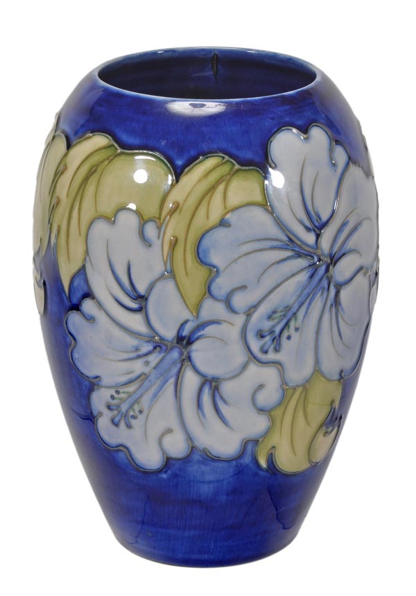 A Moorcroft ‘Hibiscus’ pattern blue-ground oviform vase, 18cm high, impressed marks and painted WM