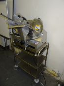 Chefquip model CQS300AUTO 300mm dia benchtop slicer mounted to 3 tier stainless steel mobile trolley
