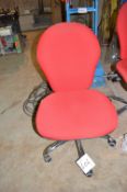 Red upholstered swivel chair