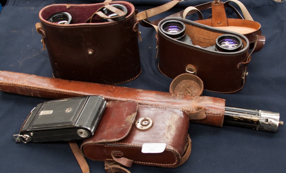 A Zeiss Ikon Nettar cased folding camera, two modern sets of binoculars and a leather cased