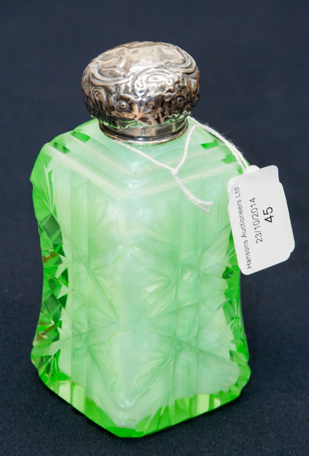 A uranium green glass dressing table (cut glass) cologne bottle with silver neck and cap London 1902
