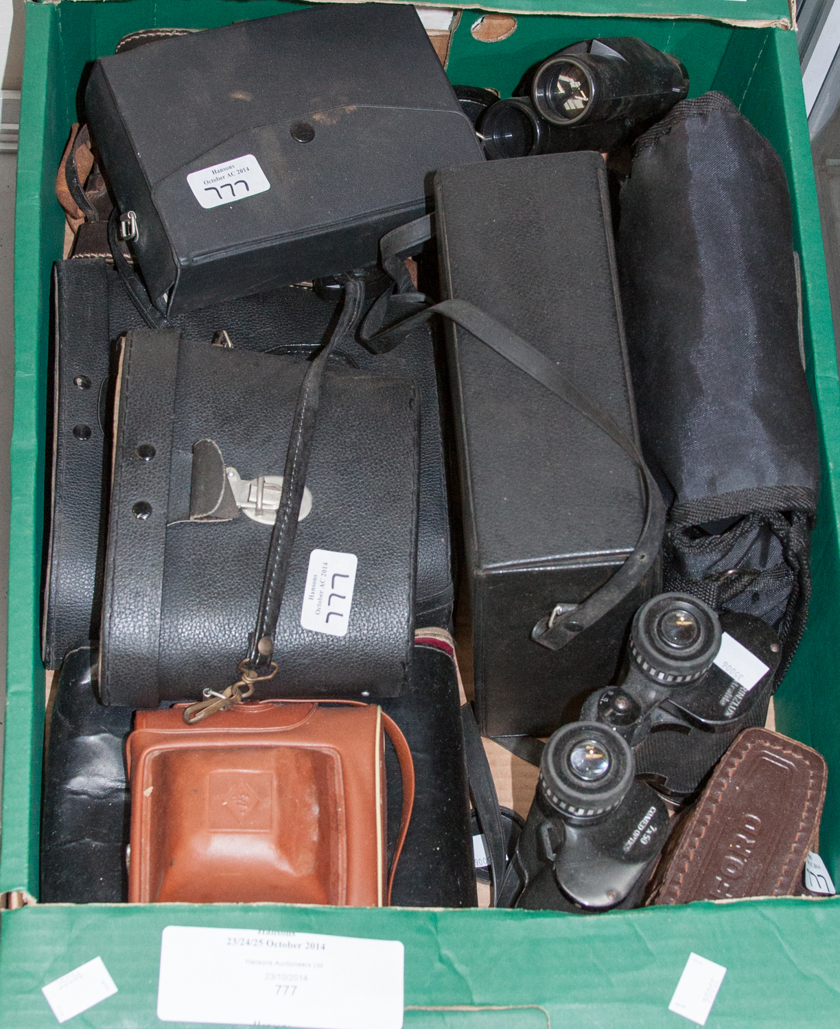 A box of binoculars and cameras, mostly late 20th Century