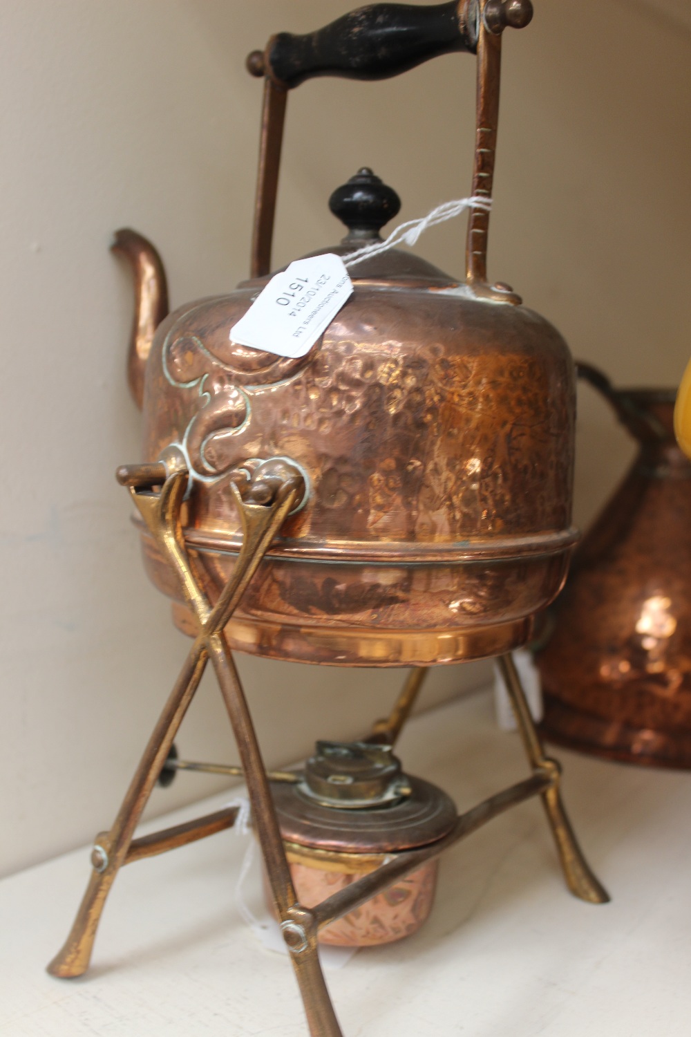 An Arts and Crafts decorated copper spirit kettle and stand