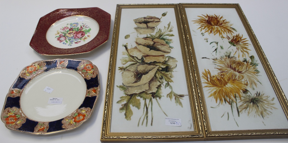 A pair of hand painted Edwardian ceramic plaques, framed, of floral design and two Victorian plates