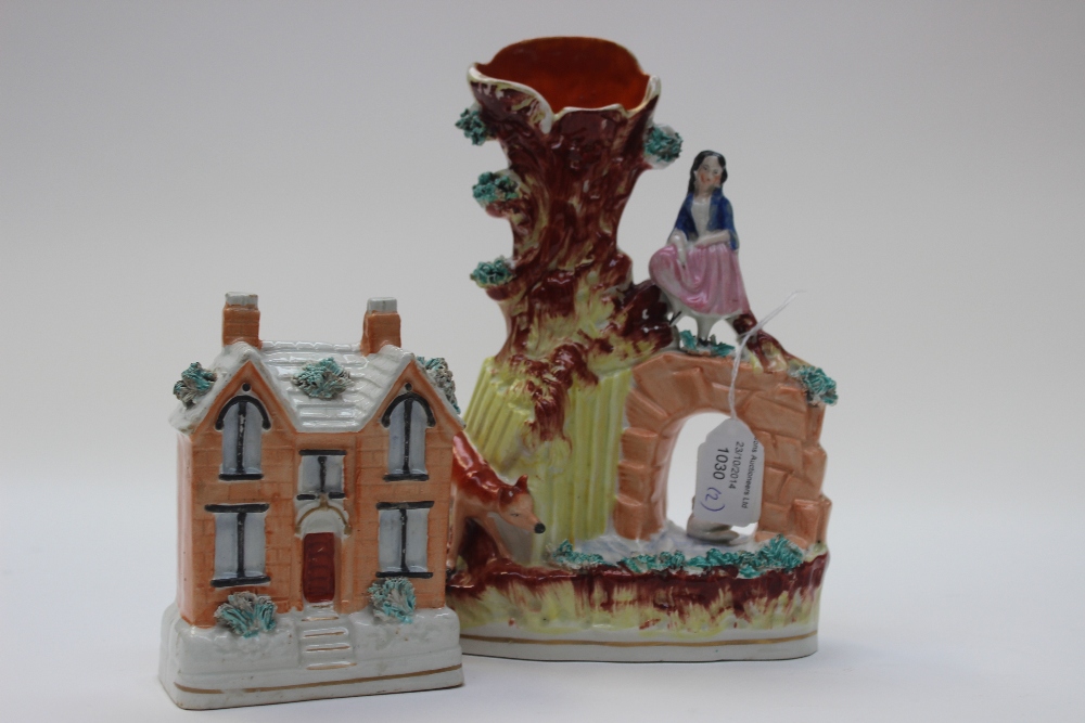 A Victorian Staffordshire pottery money box in the form of a Victorian villa and a spill vase