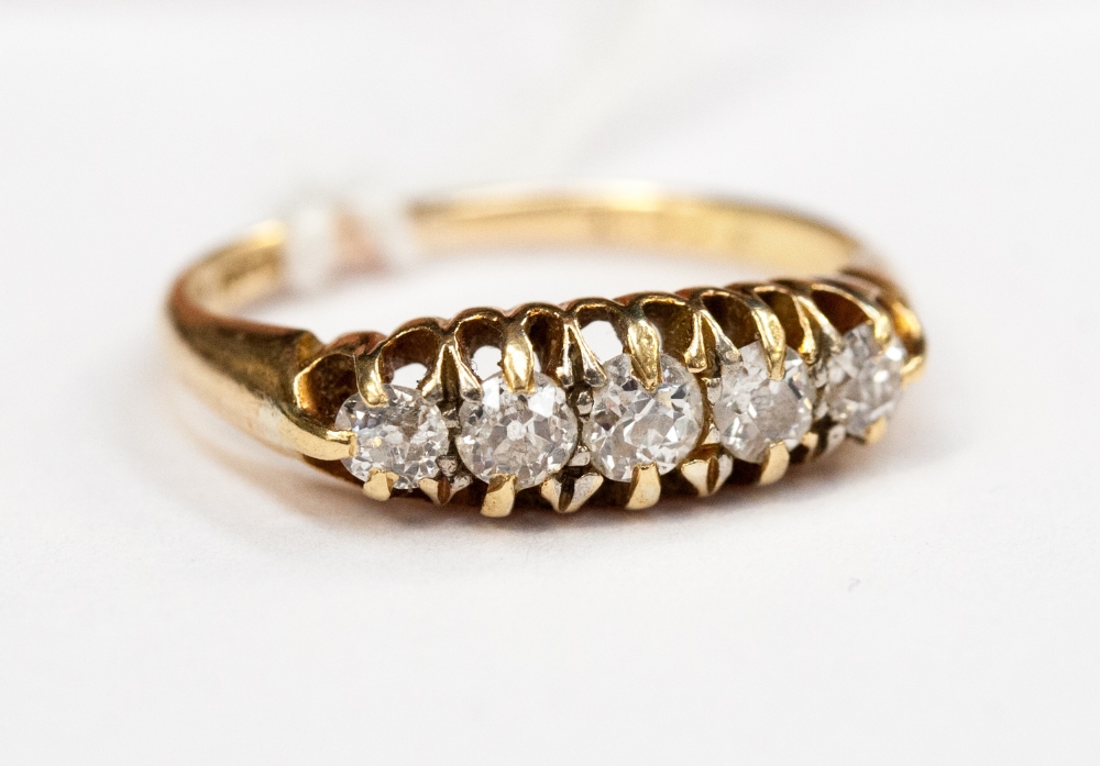 A five stone ladies diamond ring, set in yellow metal (hallmark worn)