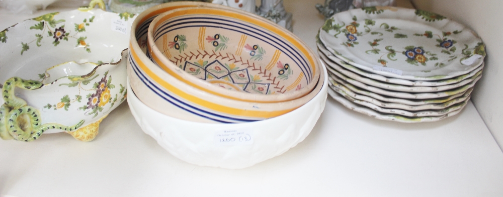 A collection of French Faience plates and tureen painted with queen orange and blue floral