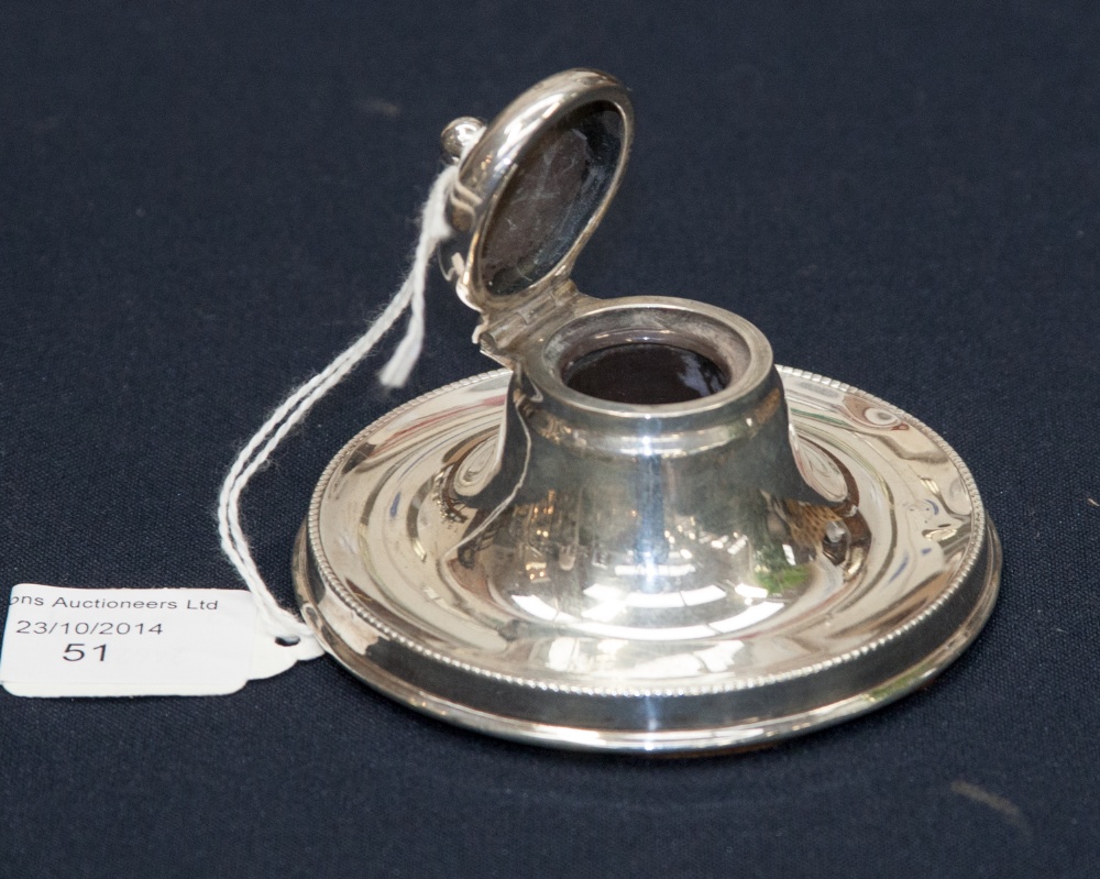 A circular silver capstan inkwell, beaded rim to base