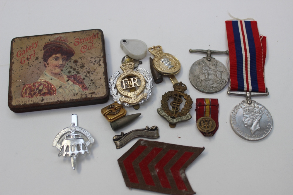 A bag of medals and badges includes WW1 Victory medals x 4, North Staffs and others
