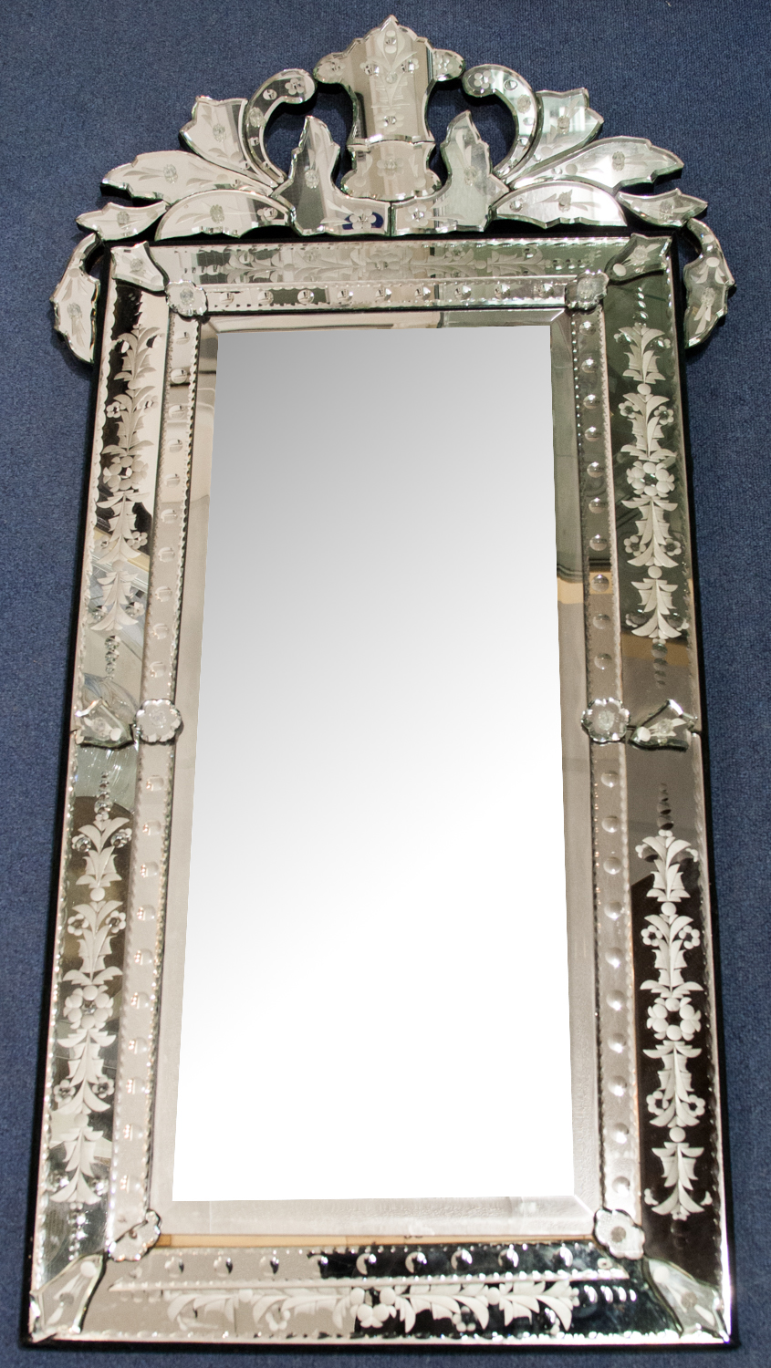 A large Venetian mirror of rectangular form, the frame etched and cut with floral patterns, with