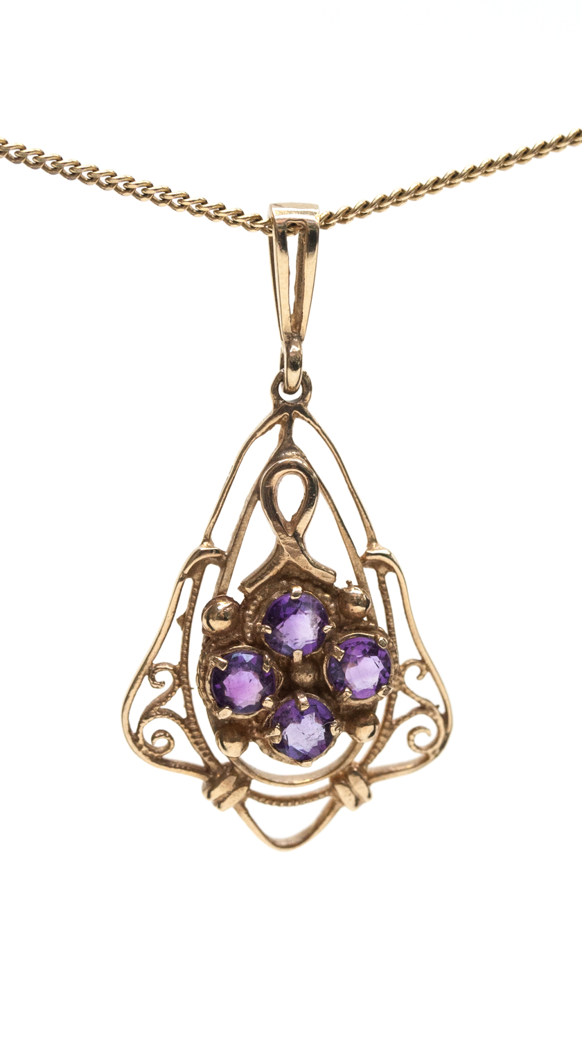 An Art Nouveau 9ct gold and amethyst pendant on gold chain, the four stones set within a teardrop