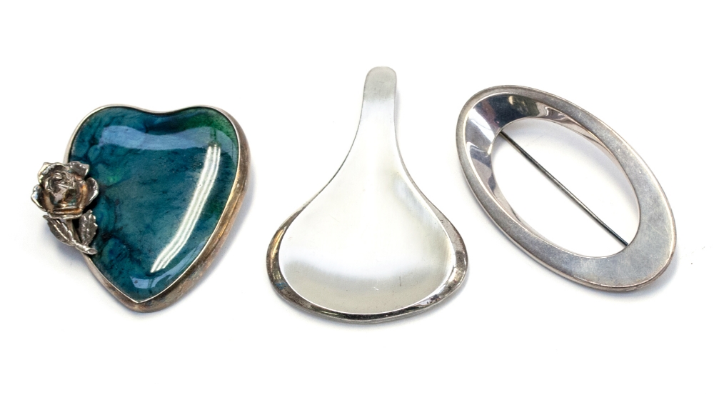 Hans Hansen, a Danish modernist silver brooch of elliptical form, together with a West German