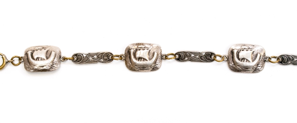 A 1930s Art Deco silver bracelet in the Scandinavian style with Viking ship motifs between scroll