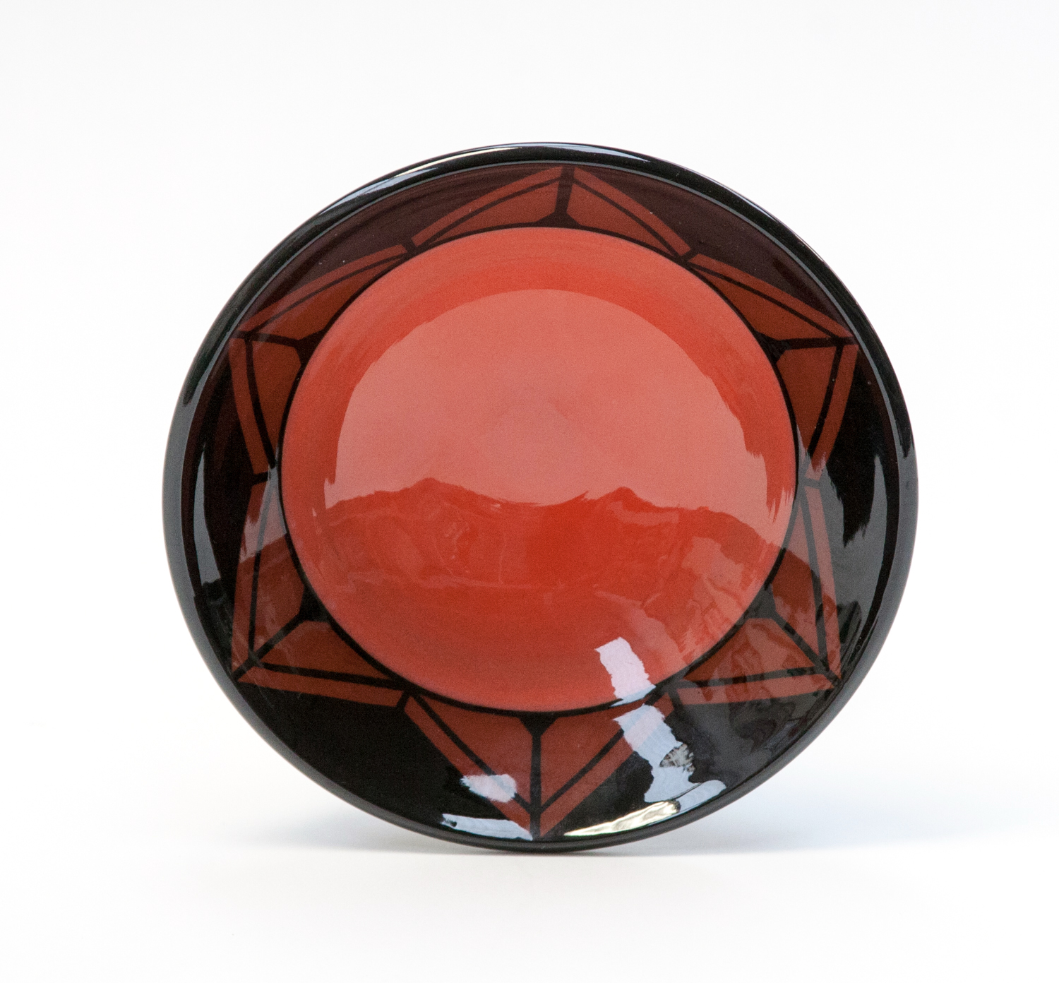 Marti Mocahbea, a studio pottery bowl, black glazed decorated with geometric red triangle border and