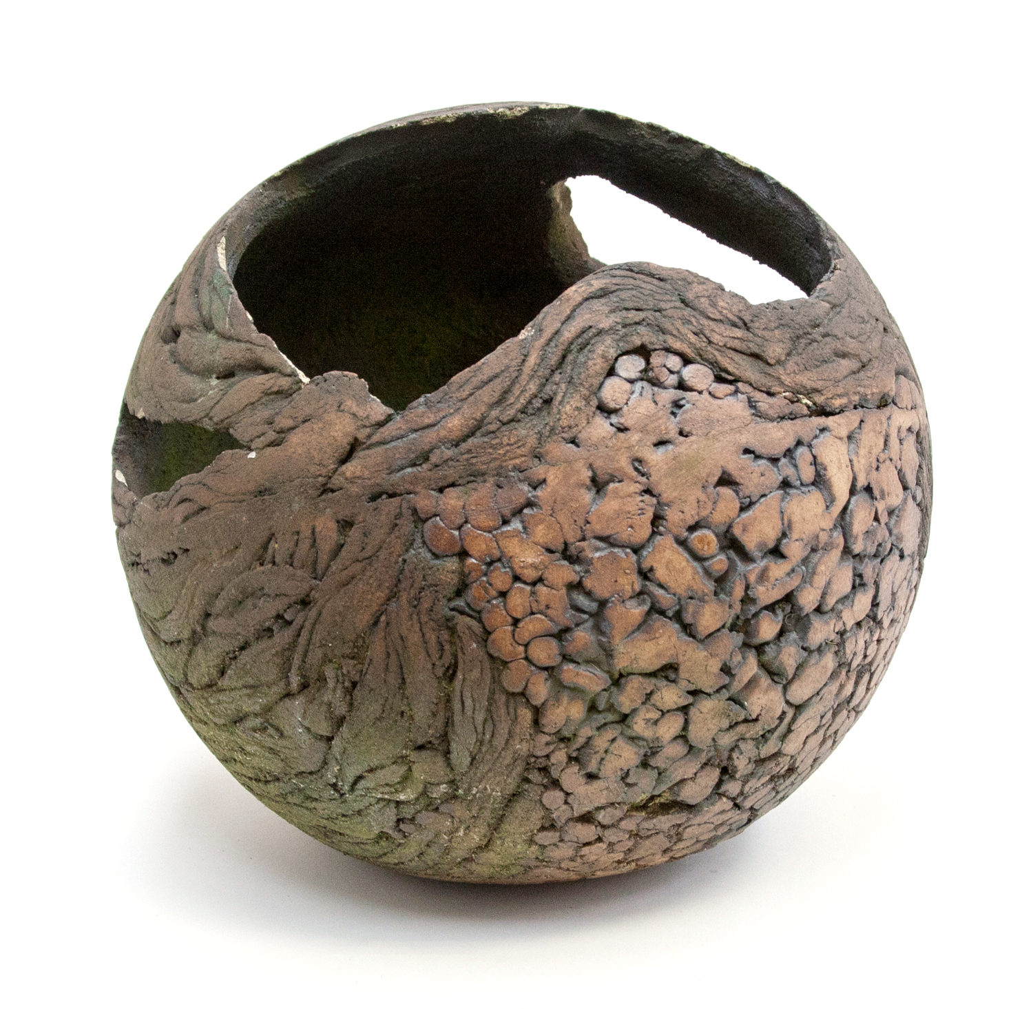 A 1970s ceramic garden planter of spherical form, weathered, textured surface, with pierced