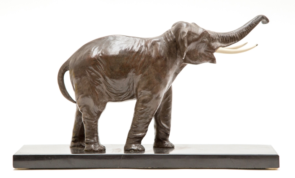 An Art Deco bronzed figure of an elephant, circa 1935, on a black marble effect rectangular base,