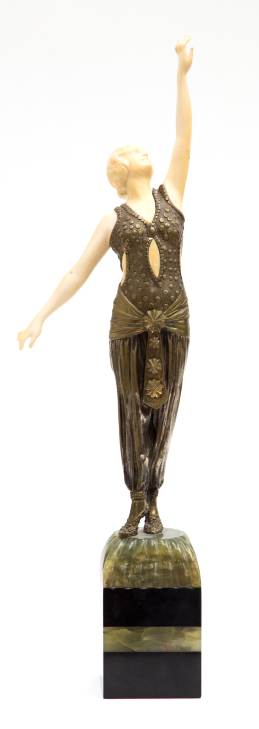 An Art Deco bronze and ivory figure, of a female dancer, arabesque arms, signed Muller, raised on