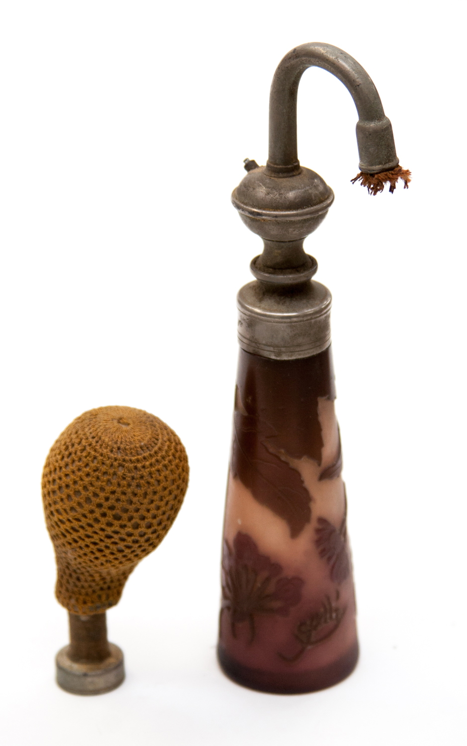 Emile Galle, an aubergine cameo glass atomiser, conical form carved with leaves and flowers, with