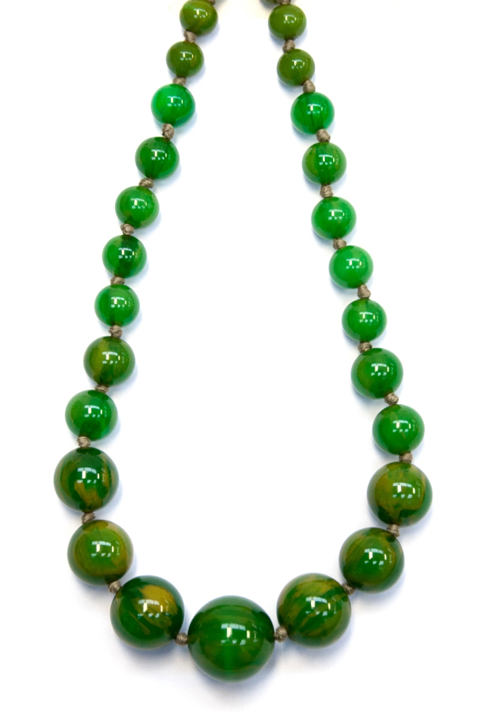 A 1920s green bakelite necklace of graduated spherical beads, 84cm long