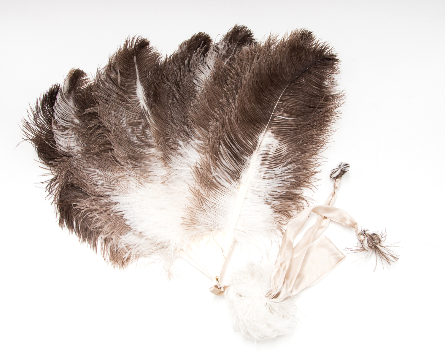 An Art Deco ostrich feather fan, circa 1925, with beige satin ribbons, 58cm long