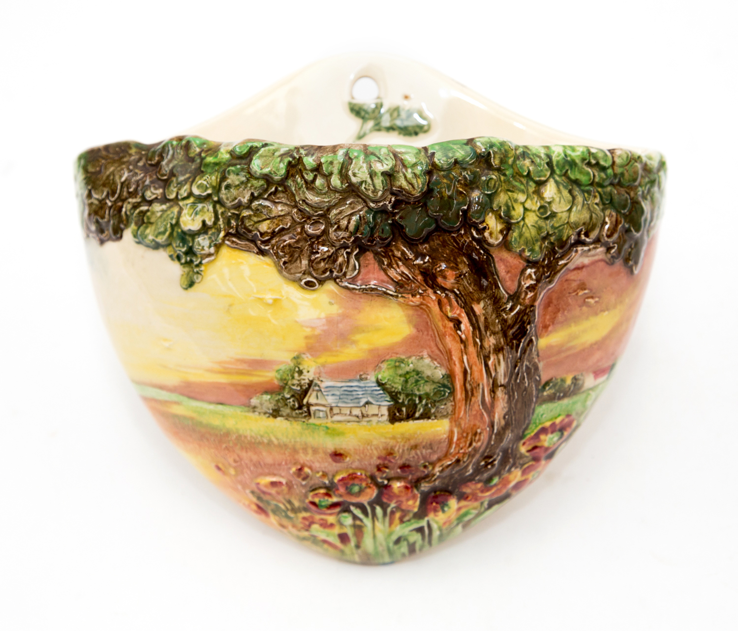 A Royal Doulton wall pocket, modelled with Oak Tree, Poppies and Cottage landscape