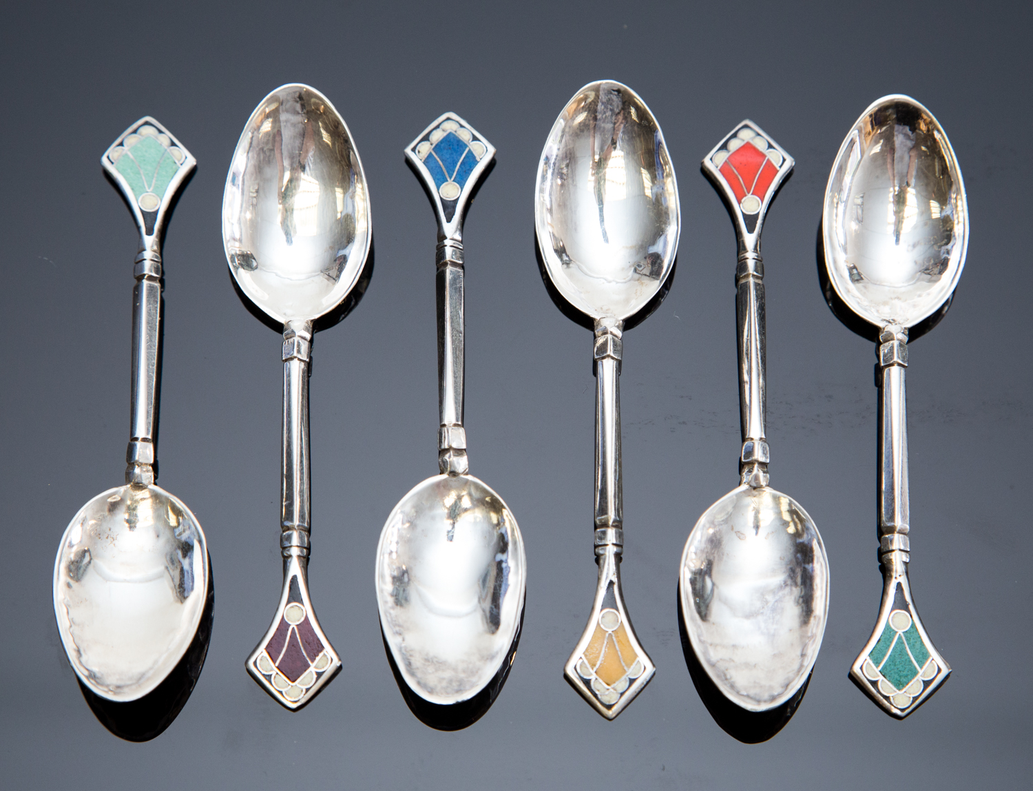 A cased set of six Art Deco enamelled silver coffee spoons, in the Secessionist style, hand hammered