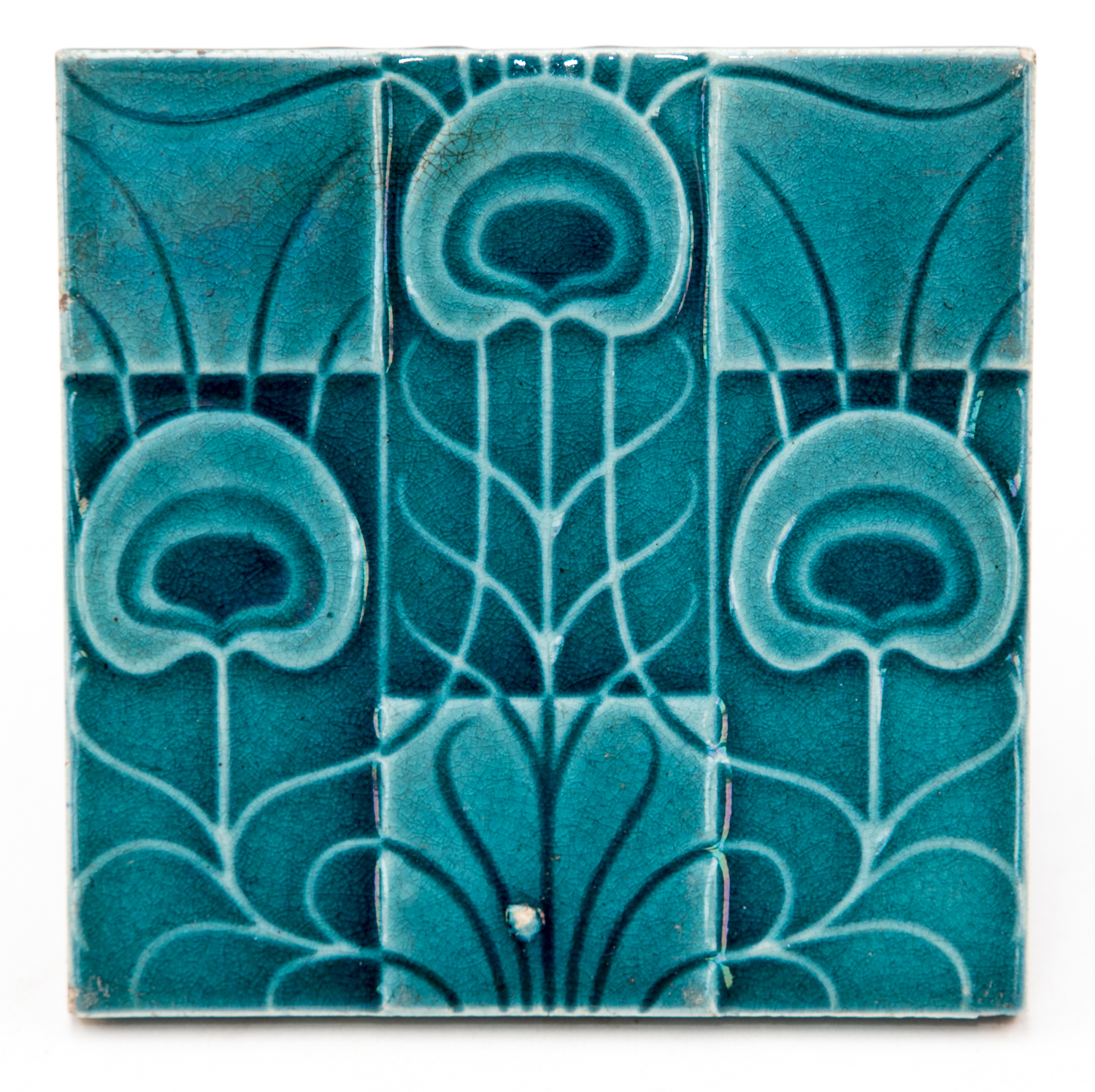 Lewis F Day, a ceramic tile, circa 1903, raised decoration of stylised peacock feathers on a check