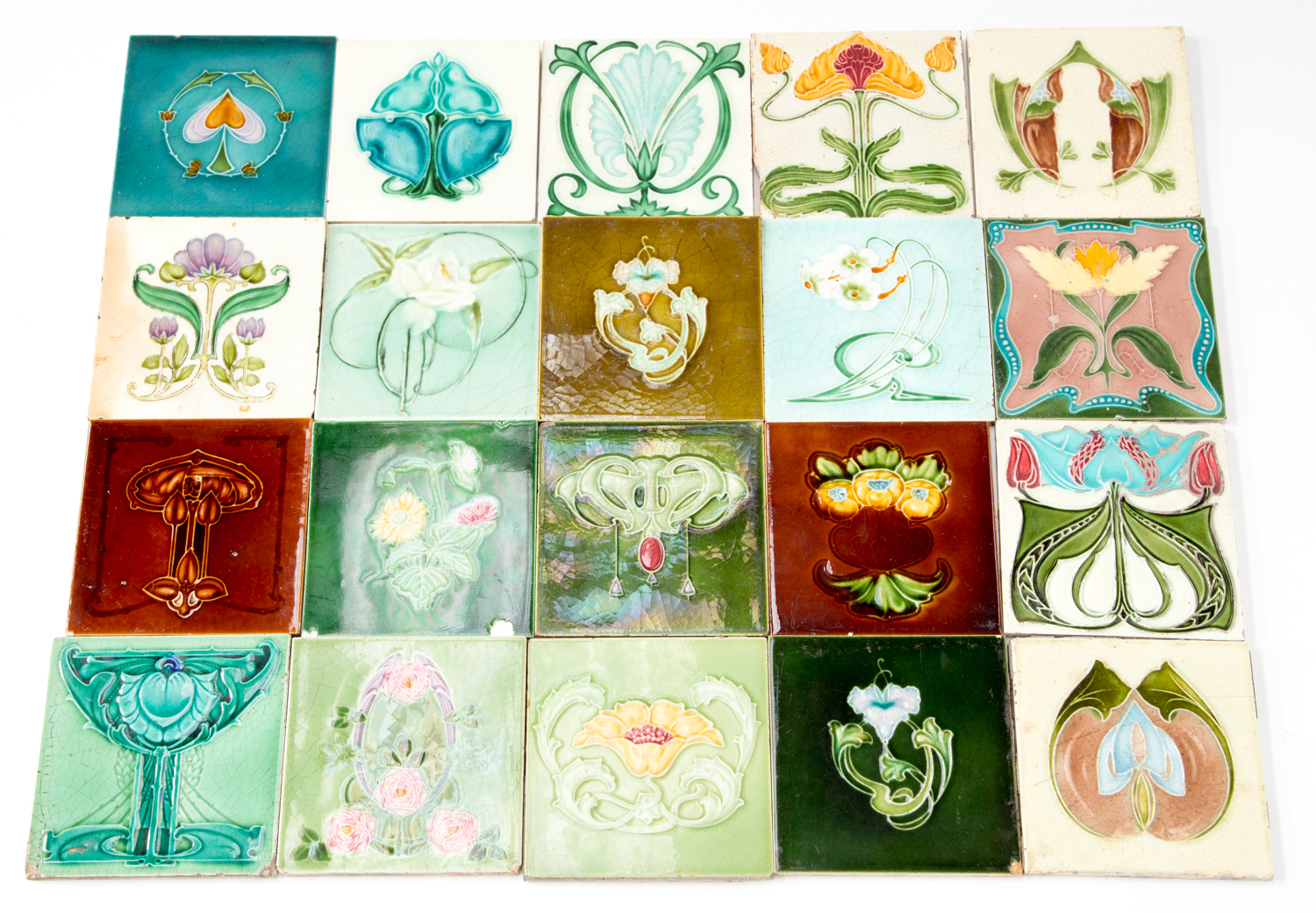 A collection of Art Nouveau majolica, tube lined tiles, various makers and designs including Minton,