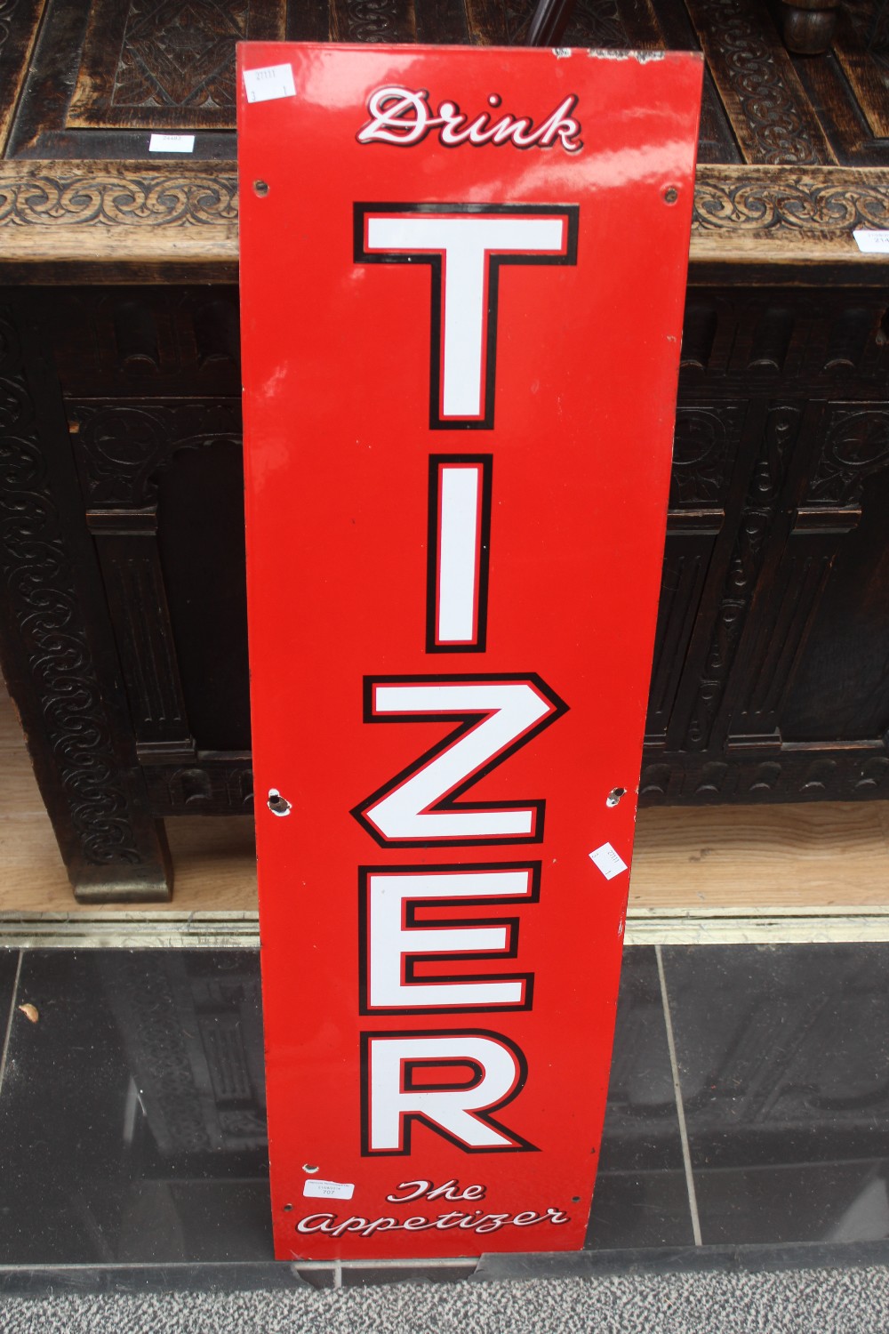 An enamelled sign for Tizer 'Drink Tizer the Appetiser' 91cm x 25.5cm.