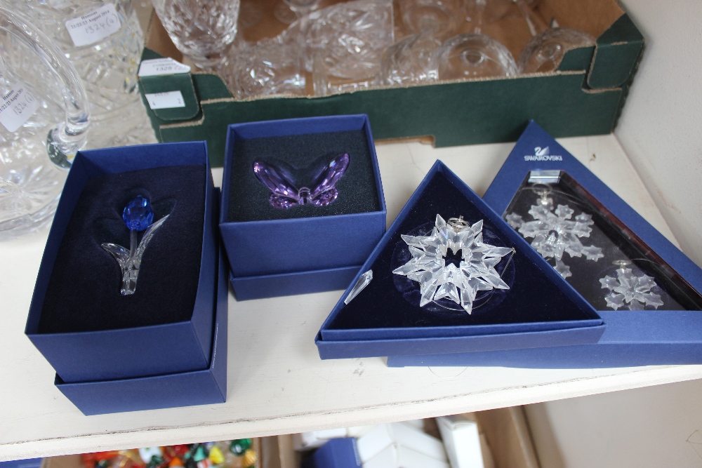 A box containing a collection of 11 Swaroski Crystal Christmas ornaments, each individually boxed,