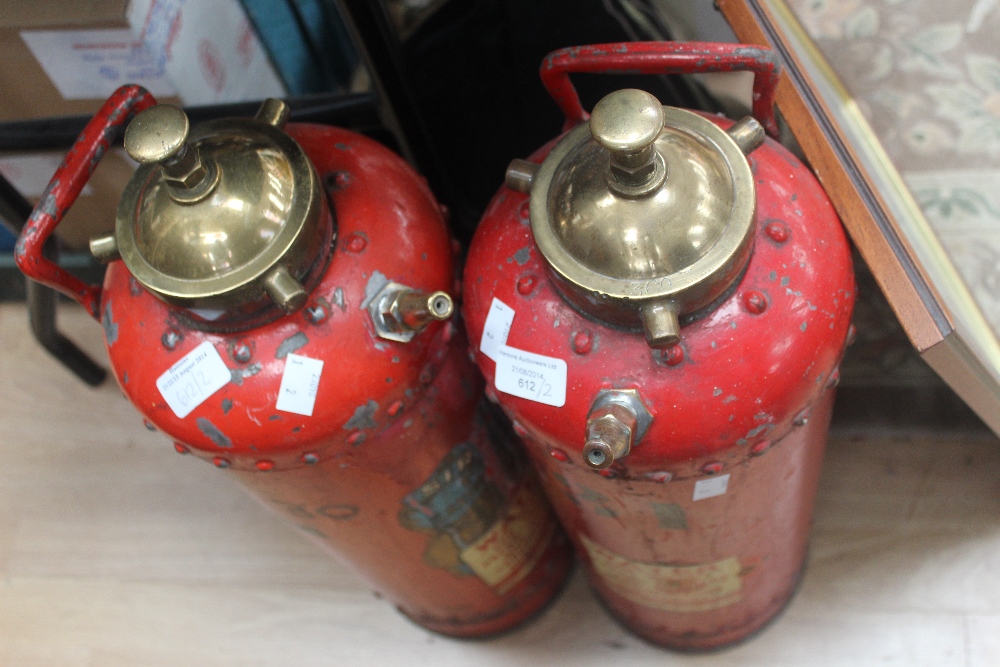 A pair of vintage fire extinguishers