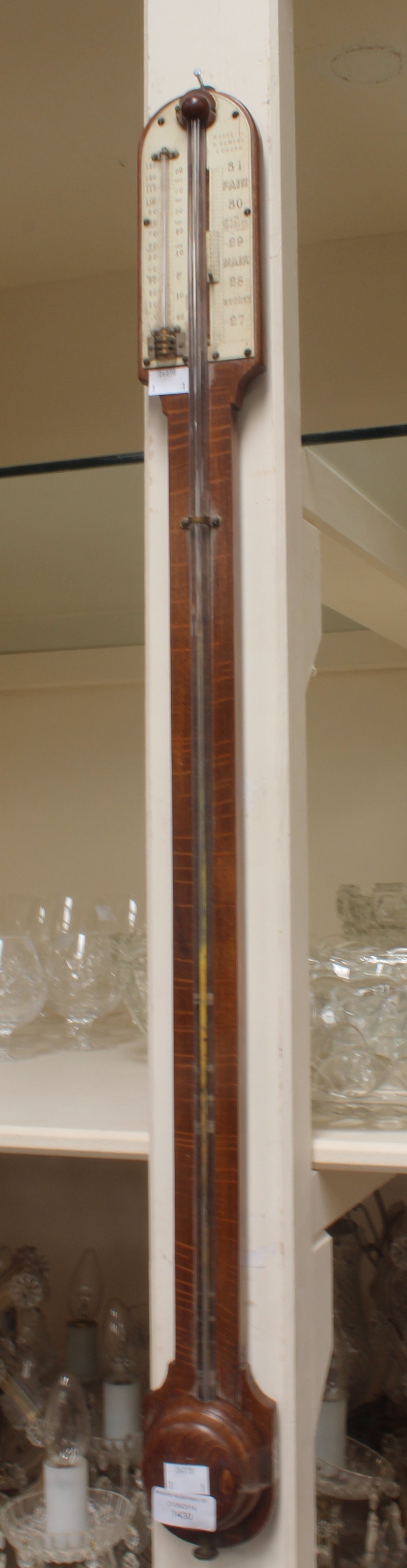 A Victorian oak cased Negretti and Zambia stick barometer, the top section with an ivory gauge