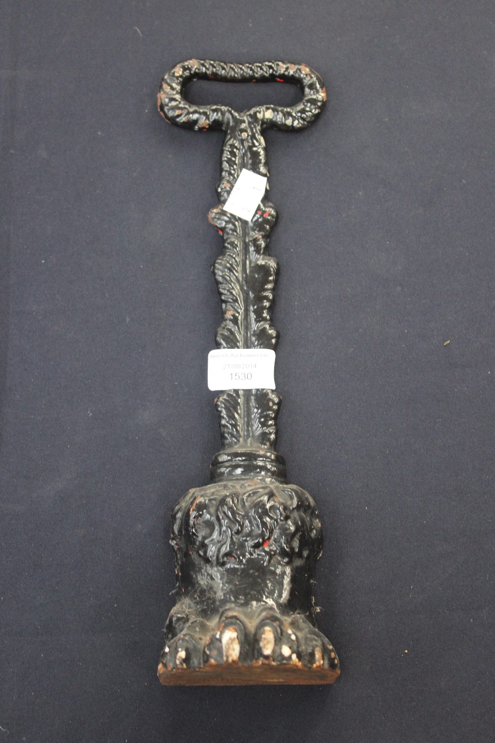 A cast iron Victorian door stop shaped as a lions foot