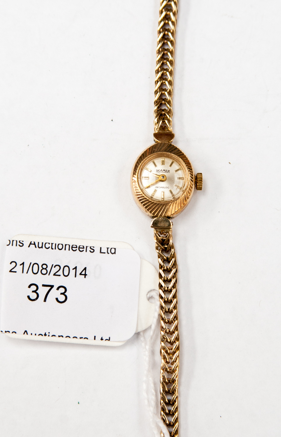 A 9ct gold ladies wristwatch on 9ct gold chain, Roamer