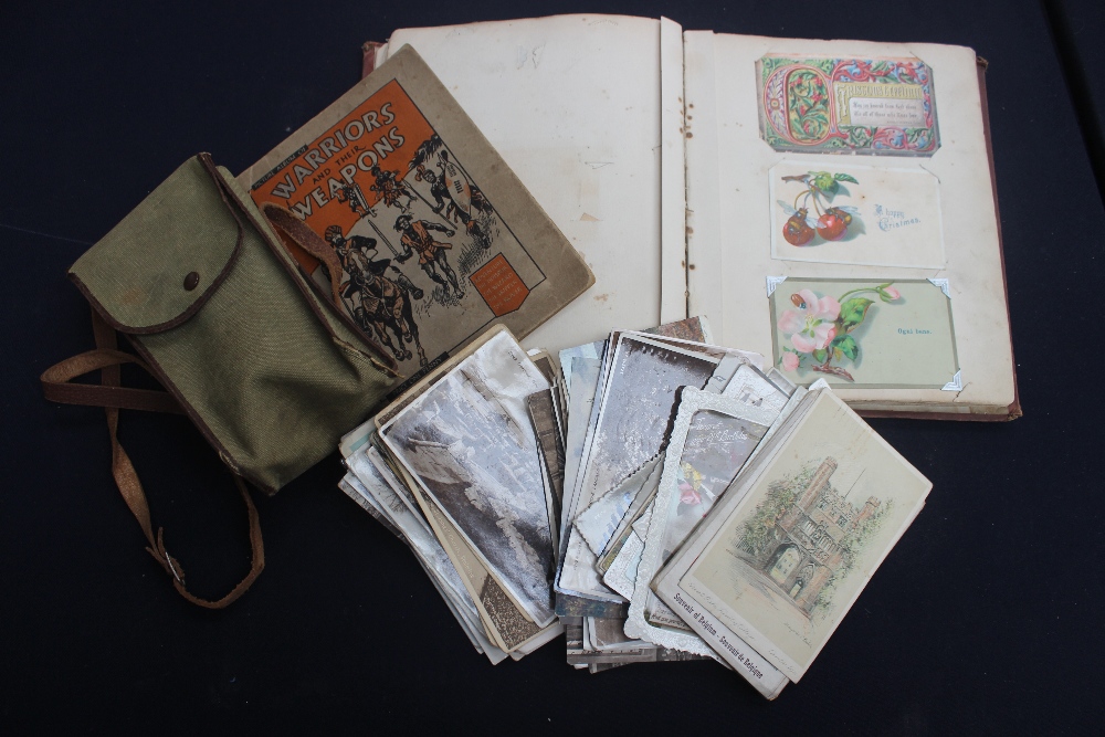 A Victorian scrap album, with dated scraps, postcards (Edwardian, WWII) comic and views etc (bundle)