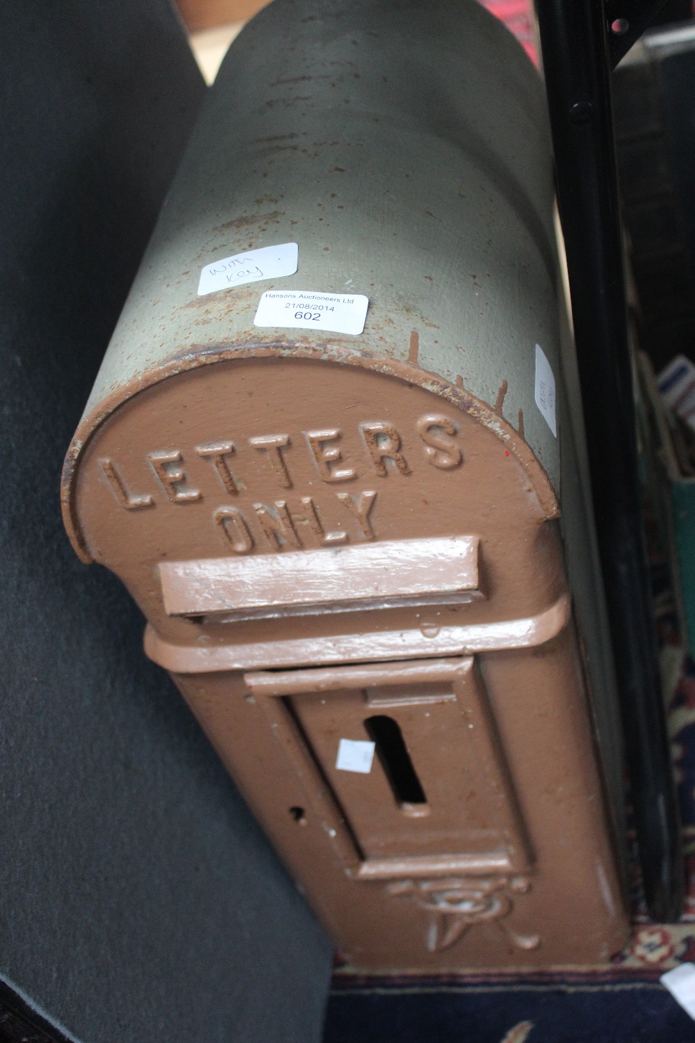 A wall mounted letter box, with dome top. Raised lettering V.R with mesh insert and two keys.