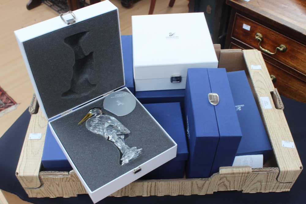 A collection of Swarovski boxed figures, including horse figure group, a mythical horse figure, a