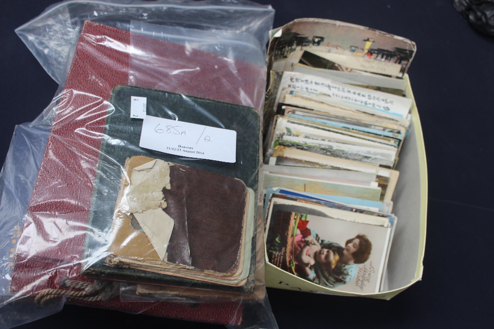 A box of assorted post cards, photograph albums, autograph albums, etc