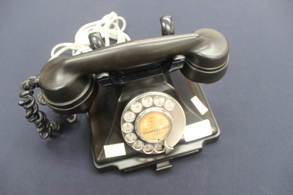 A black Bakelite telephone 1/232L in working order, dated 1945