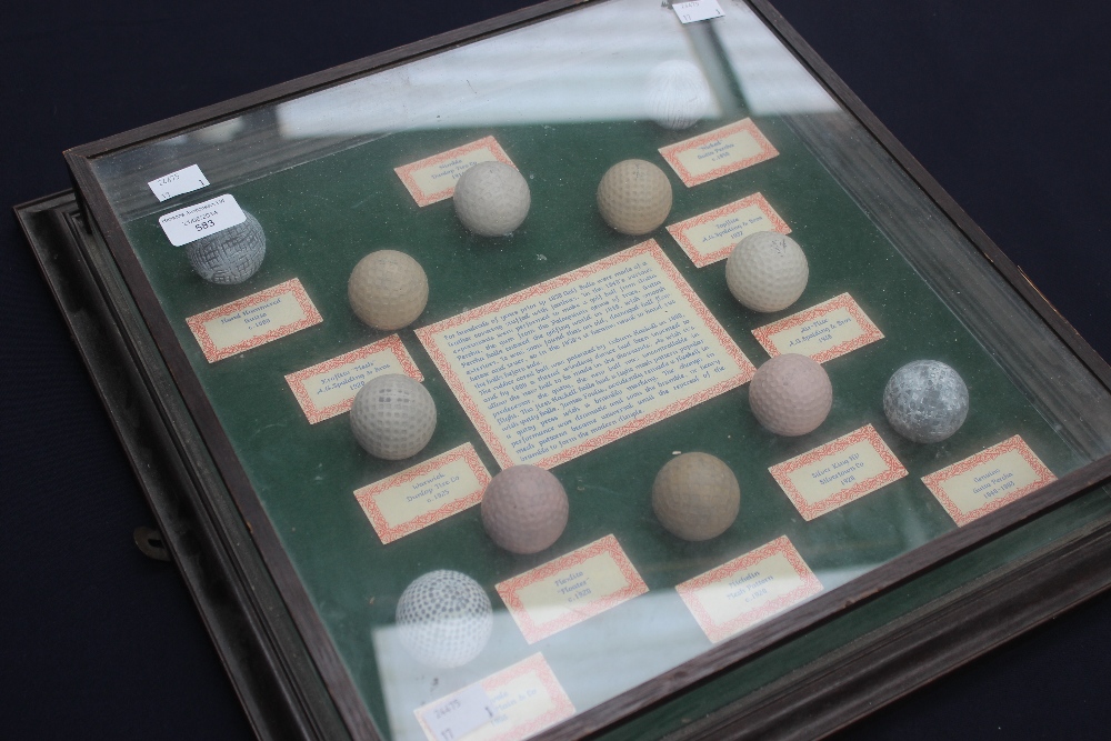 A boxed display collection of historic golf balls, dating from the mid 19th century onwards.