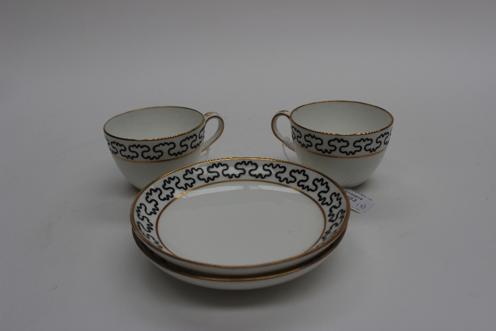 Two Spode Pinxton replacement cups and saucers black wavy line between gilt borders, unmarked