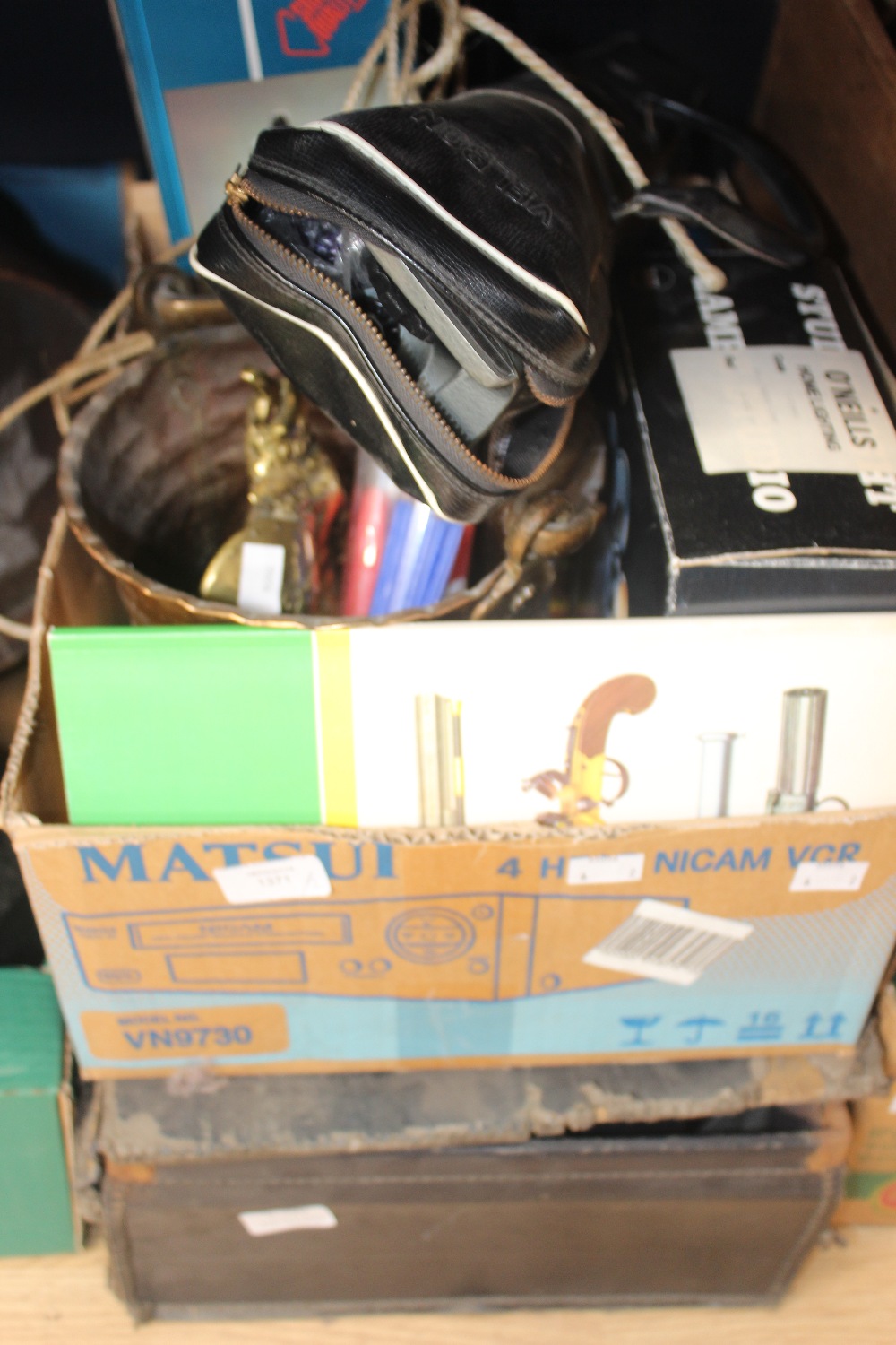 A box of brassware and household goods and a case of film reels and a vintage home movie