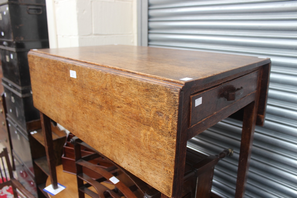An early 19th century oak Pembroke table, fitted with a single drawer and raised on square