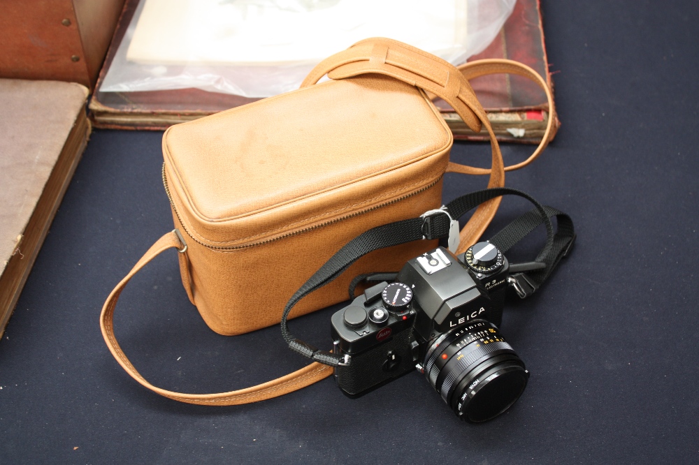 A Leica R3 camera with instruction manual and card; in a tan colour carry case