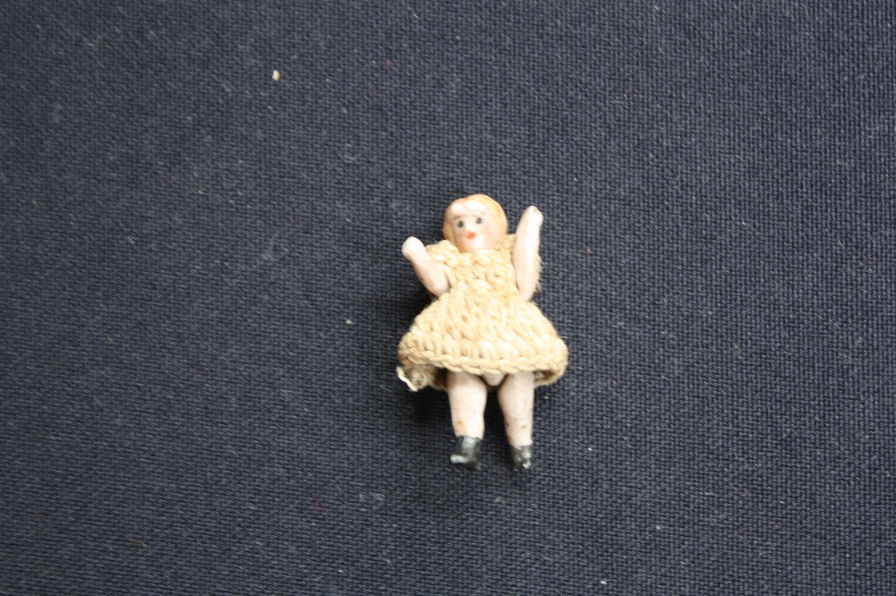 A miniature dolls house doll (German)