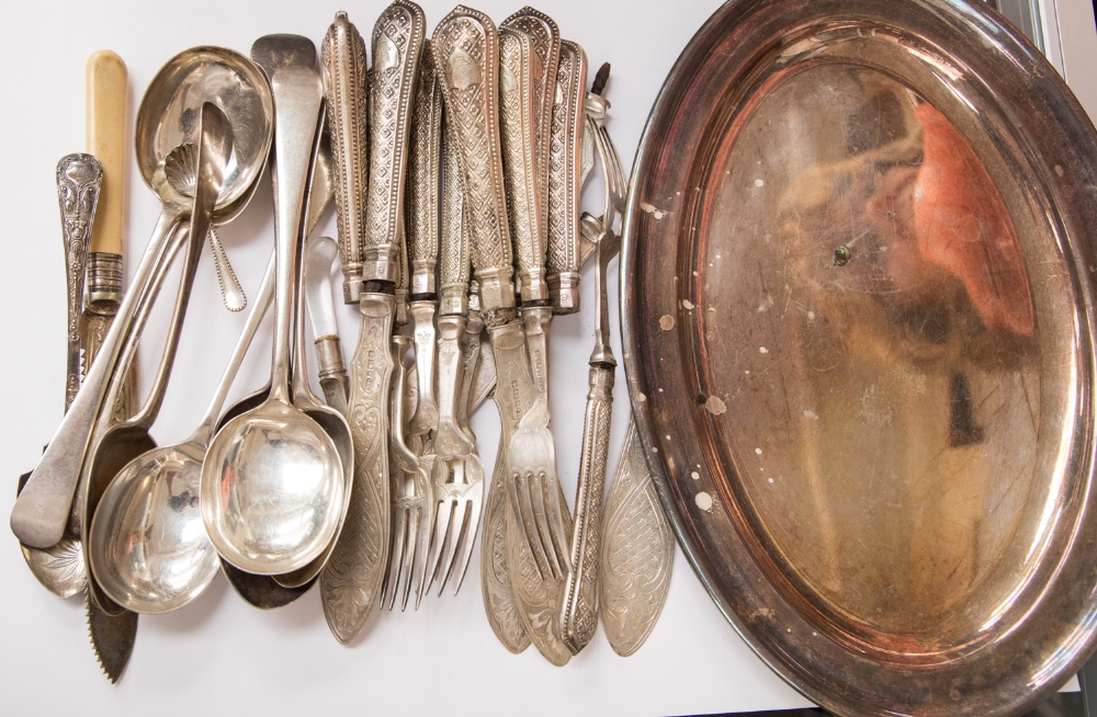 A box of loose plated flatware and cutlery and an oval platter