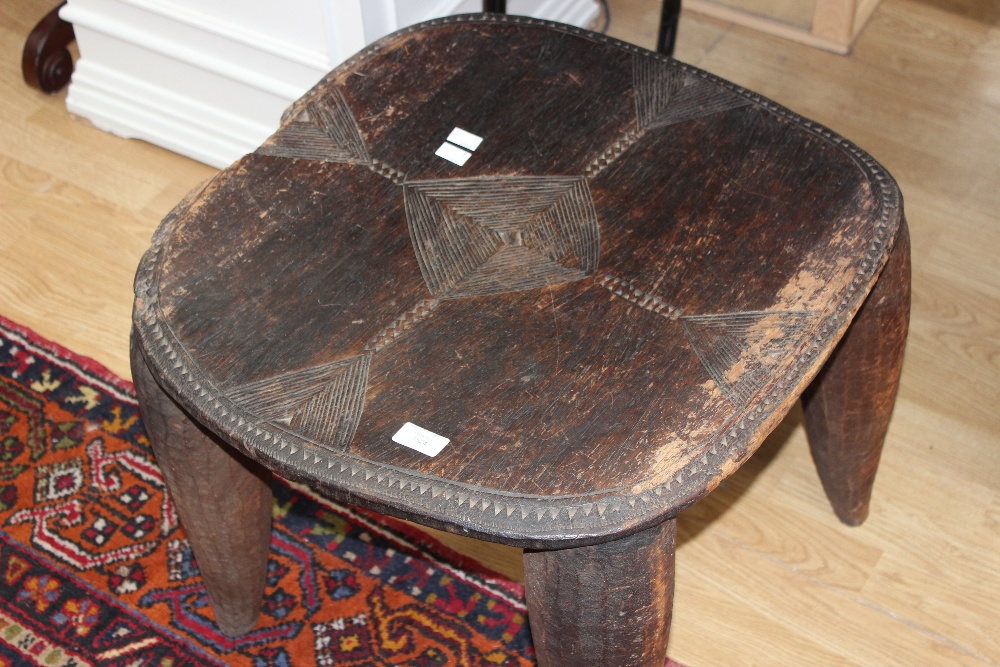An African tribal hardwood low table with carved decoration